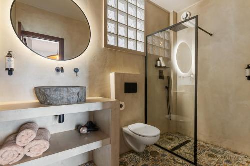 a bathroom with a sink and a toilet and a mirror at Casa Carpa Andalucia IV Carabeo Playa in Nerja
