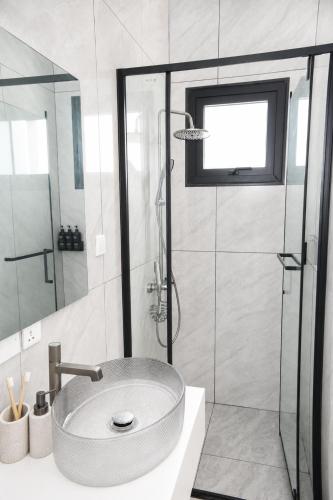 a bathroom with a sink and a shower at Elite Residence in Accra