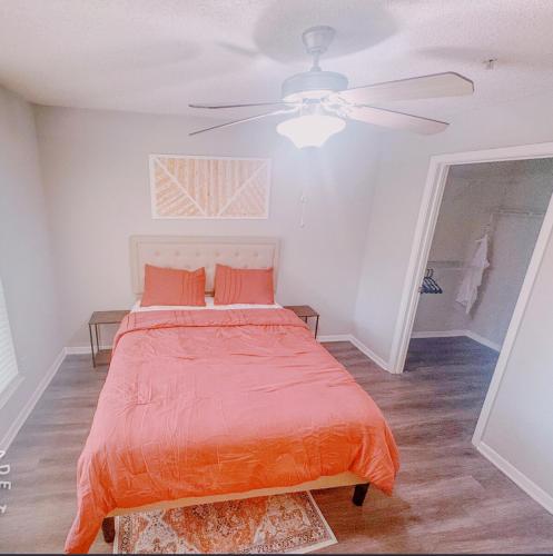 a bedroom with a bed and a ceiling fan at Cozy ATL Retreat in Decatur