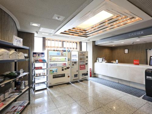 a restaurant with two refrigerators and a counter at Tabist THE GREEN SAPPORO in Sapporo