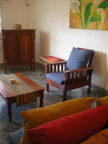 a living room with a couch and a chair at Casa Jaguar in Copan Ruinas