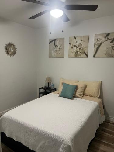 a bedroom with a large bed with a ceiling fan at West Mitchell in Phoenix