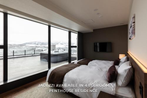 a bedroom with a large bed and a balcony at The Vale Rusutsu in Rusutsu