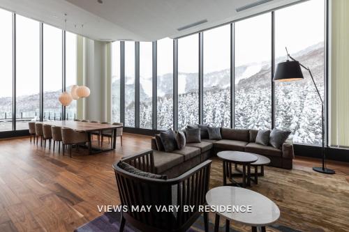 a living room with a couch and a table at The Vale Rusutsu in Rusutsu
