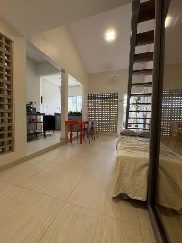 a bedroom with a loft bed and a dining room at Casa Loft 9C in São Luís