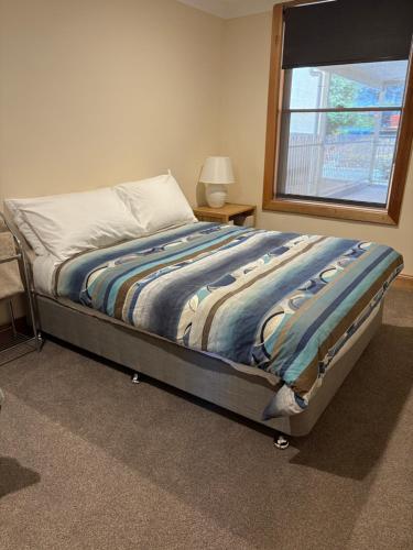 a bed in a bedroom with a window at Williamstown Bed and Breakfast in Williamstown