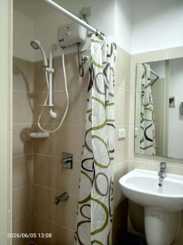 a bathroom with a shower and a sink at Grand Riviera neas Slec in Manila