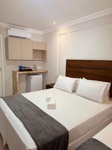 a bedroom with a large bed with a towel on it at Hotel Vistta Iracema in Fortaleza