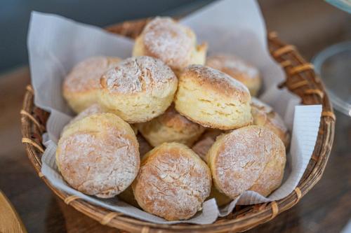 a basket filled with donuts sitting on top of a table at Hotel Casagrande in Paysandú