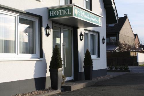 a hotel sign on the front of a building at Hotel Am Wintergarten in Bocholt