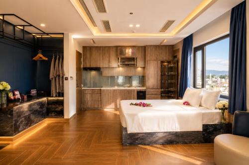 a bedroom with a large bed and a kitchen at W Premium Nha Trang in Nha Trang