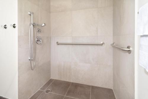 a bathroom with a shower with a glass door at Candlewood Suites - Celaya by IHG in Celaya