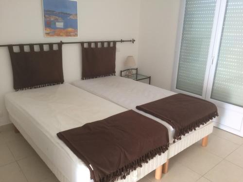 a bedroom with a large bed with brown pillows at Monte san petru in Propriano