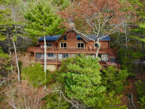 a large wooden house on a hill with trees at Angels Envy in Lenoir