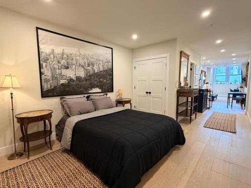 a bedroom with a bed with a large painting on the wall at The Hudson Horizon in West New York
