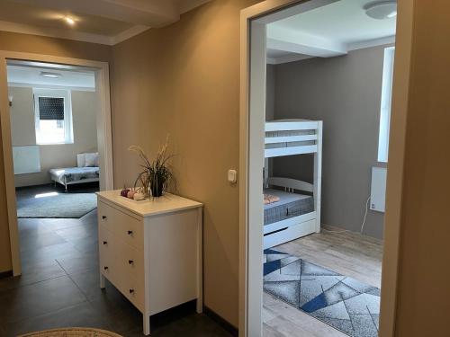 a small bedroom with a bunk bed and a dresser at FeWo Steineck leutenberg in Leutenberg