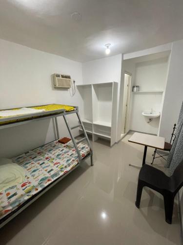 a small room with a bunk bed and a chair at Kwarto-2-Go in Pontud