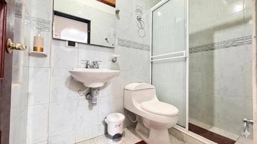 a bathroom with a toilet and a sink at Urban House in Florencia