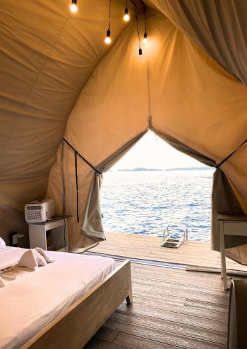 a tent on a boat in the water at Reef Resort - Mount Apo View Unit B4 in Kaputian