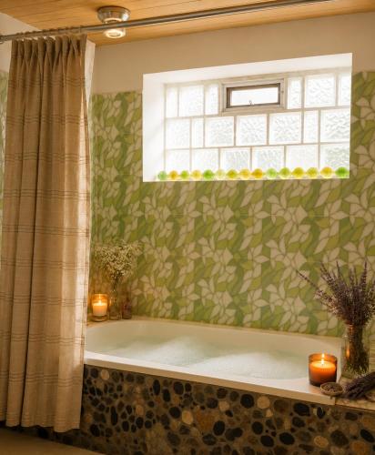 a bath tub in a bathroom with a window at IntiRumi Inn in Caraz