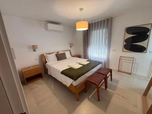 a bedroom with a bed and a table in it at Terrace Ferragudo River View Flat Super in Ferragudo
