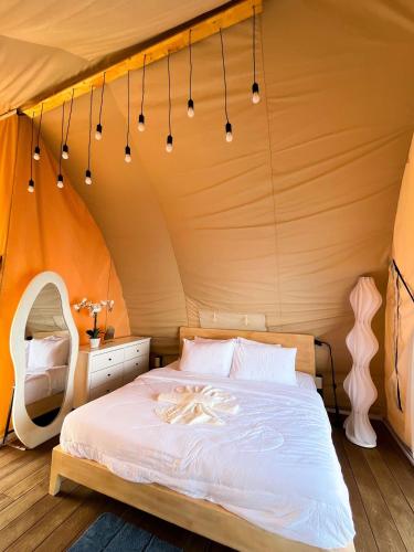 a bedroom with a bed in a tent at Reef Resort - Samal Island View Unit B8 in Kaputian