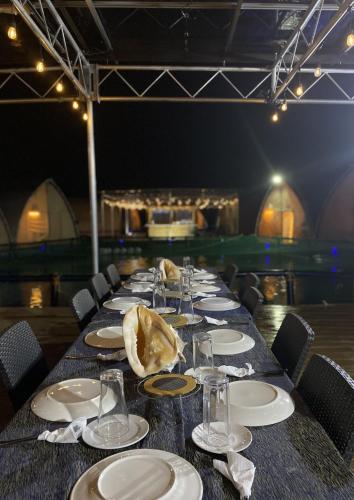 a long table with plates and glasses on it at Reef Resort - Samal Island View Unit B8 in Kaputian