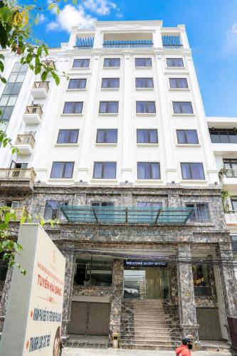 a large white building with stairs in front of it at Glory Hotel Apartment Hải Phòng in Hai Phong