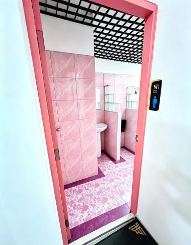 a pink bathroom with a sink and a toilet at BG prosper Hostel in Ban Don Muang (1)