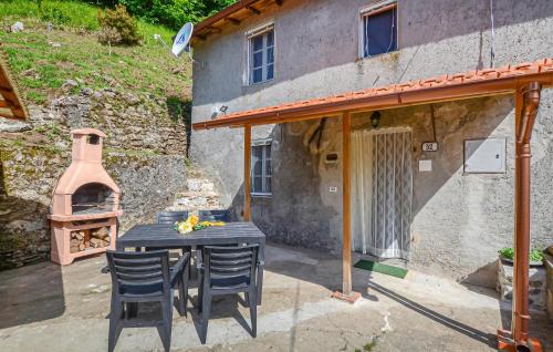 a patio with a table and a pizza oven at Casa Sant'anna in Stazzema