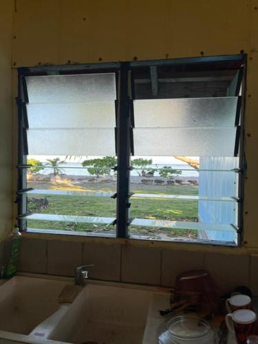 a kitchen window with a view of a field at Camping Hiva Plage in Parea