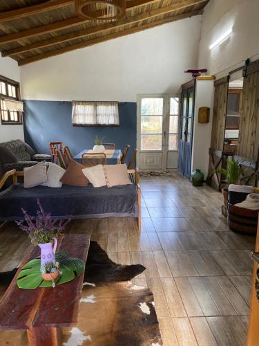 a living room with a bed and a table at Sitio Piruetas in Santana do Livramento