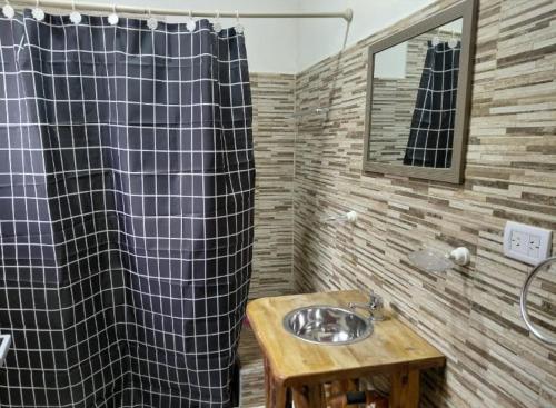 a bathroom with a sink and a shower at CATALINA in Neuquén