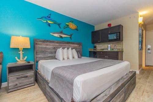 a bedroom with a bed with fish on the wall at Landmark 618 in Myrtle Beach