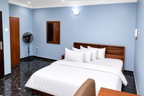 a hotel room with a bed with a person sitting on it at Executive Private Bed and Bath in Otta