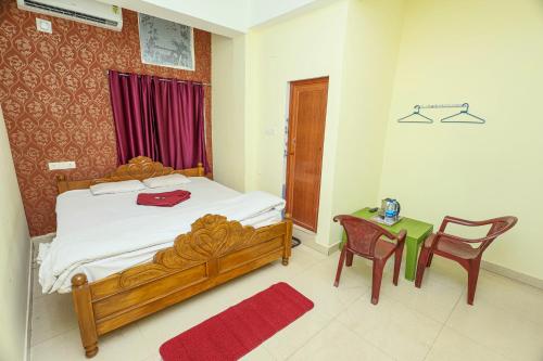 a bedroom with a bed and a table and chairs at Silver residency in Bhubaneshwar