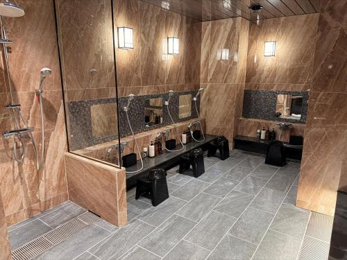 a bathroom with three sinks and a shower at HOTEL LiVEMAX BUDGET Hiratsuka Ekimae in Hiratsuka