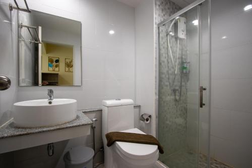a bathroom with a sink and a toilet and a shower at Wellness World Chiva Khao Yai in Ban Wang Sai