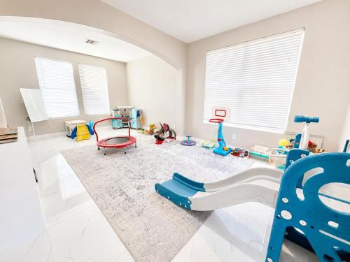 a room with a play room with toys on the floor at No Added Fees! Craig Ranch HomeShare Retreat in Las Vegas
