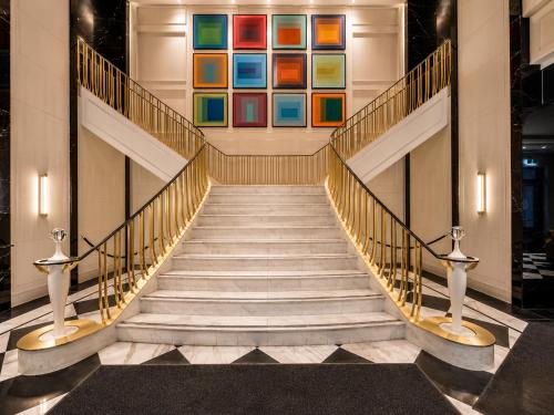 a staircase in a building with a painting on the wall at Regis Suites - Downtown Toronto in Toronto