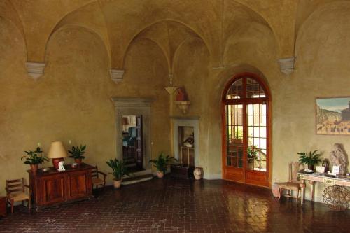 a living room with a large room with a large door at Villa Rucellai in Prato