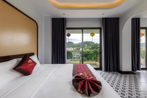 a bedroom with a bed with a bow on it at Le Maison Tam Coc Boutique Hotel in Ninh Binh