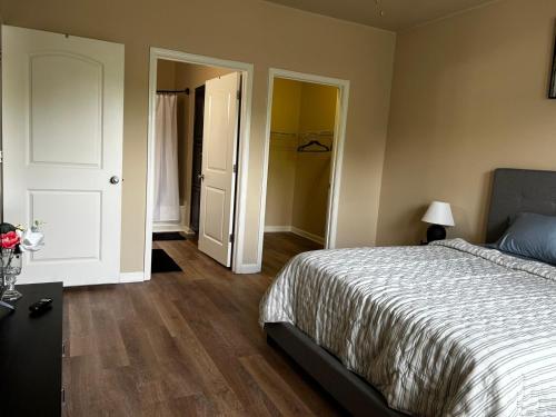 a bedroom with a bed and a door to a closet at Regatta Getaway in Fayetteville