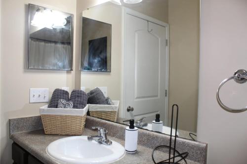 a bathroom with a sink and a mirror at Regatta Getaway in Fayetteville