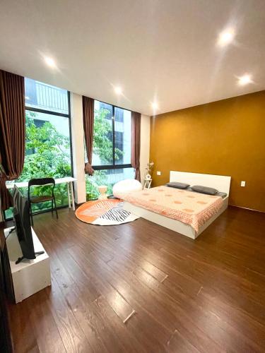 a bedroom with a bed and a large window at Cat Lai Garden Villa in Ho Chi Minh City