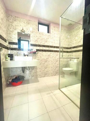 a bathroom with a sink and a toilet at Cat Lai Garden Villa in Ho Chi Minh City