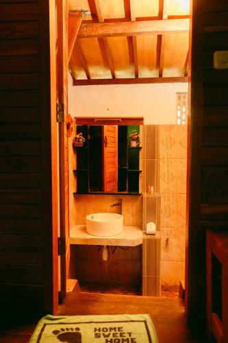 a bathroom with a sink and a mirror at Banana Leaf Bungalow in Gili Trawangan