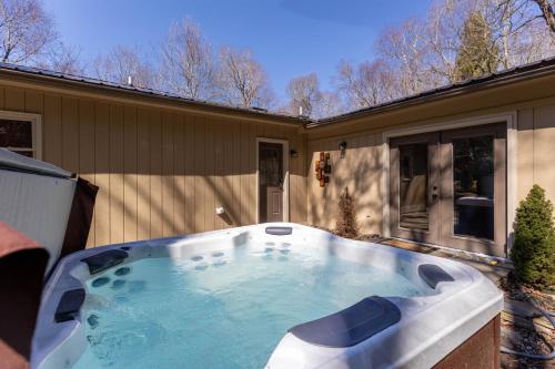 a hot tub in the backyard of a house at Snaggys Retreat in Boone