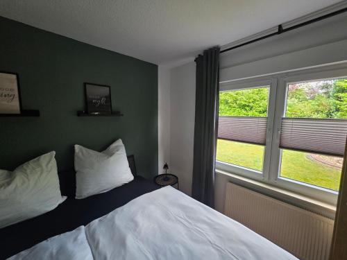 a bedroom with a bed and a large window at Haus Thieke in Rhederfeld