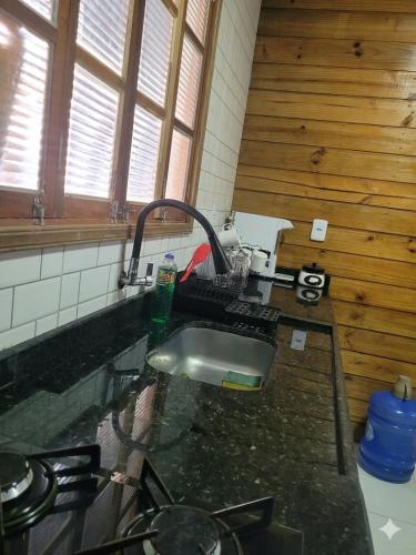 a kitchen with a sink and a counter top at Casa da Brisa in Salinópolis